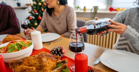 pouring wine at holiday party