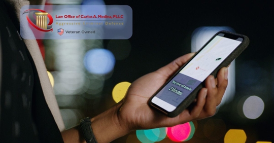 holding phone with rideshare GPS on it